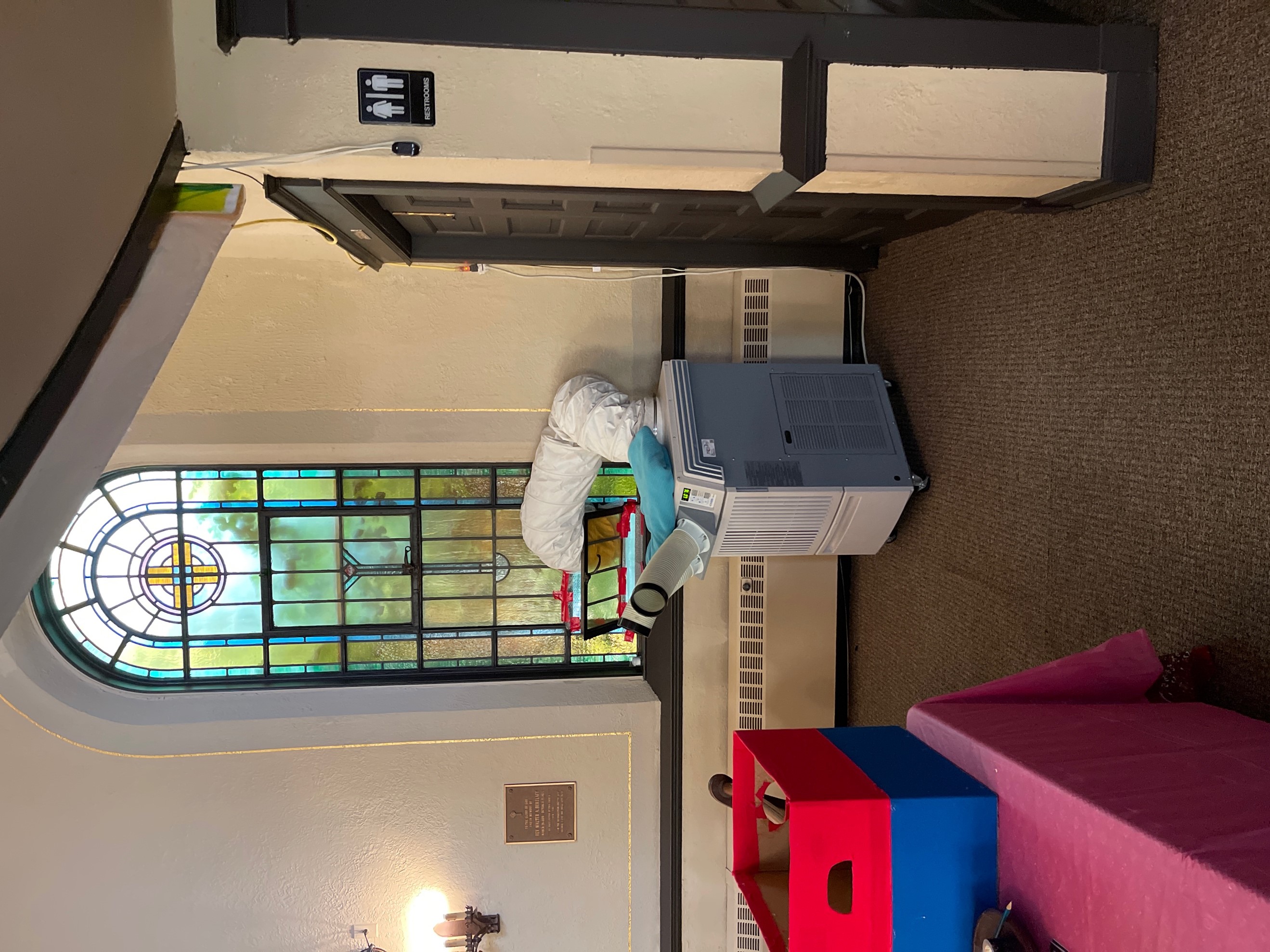Office Pro, portable AC ducted through stained glass window in Church. 